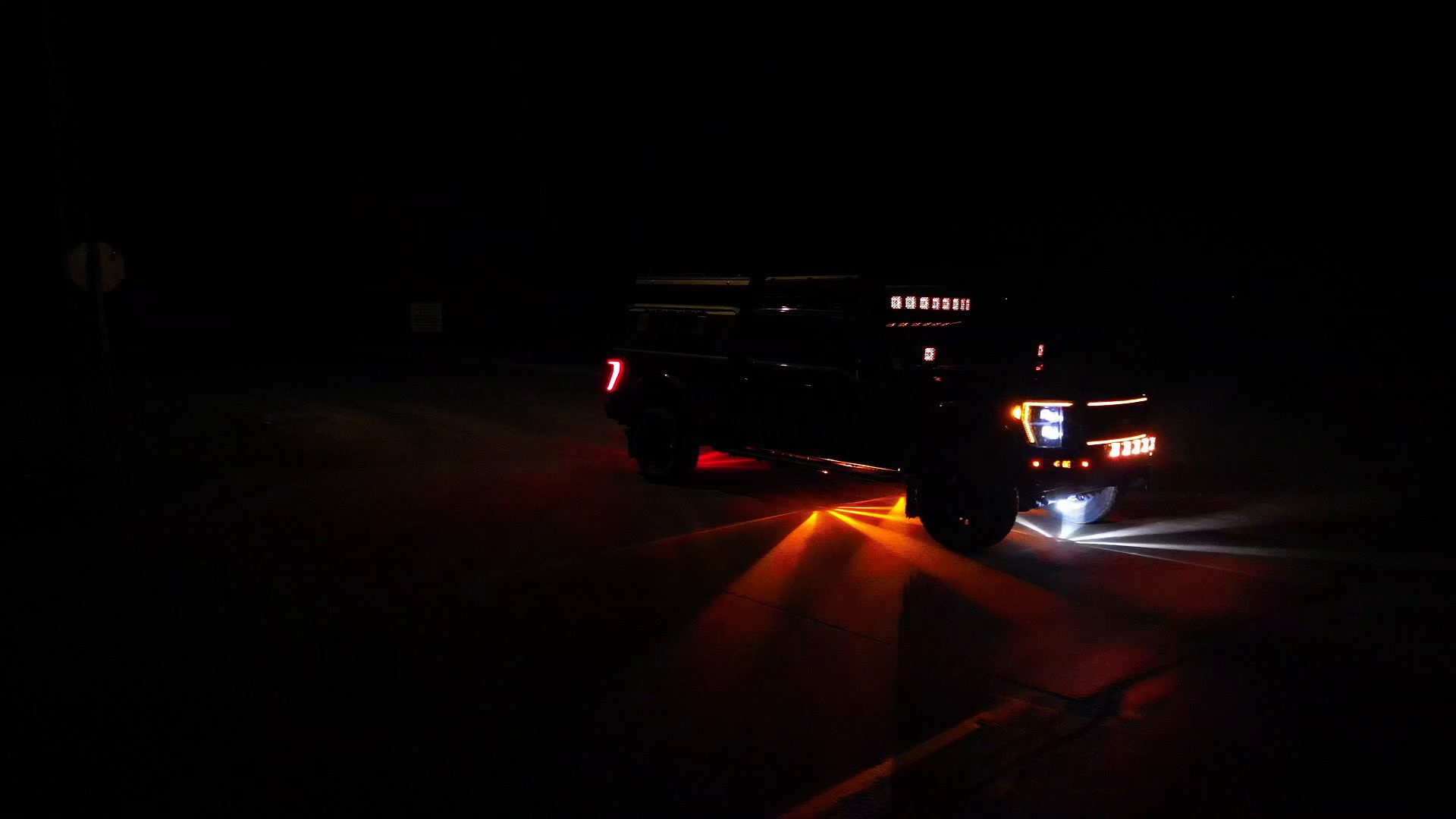 BTS pickup displaying Alpha 360 light patterns on the road at night