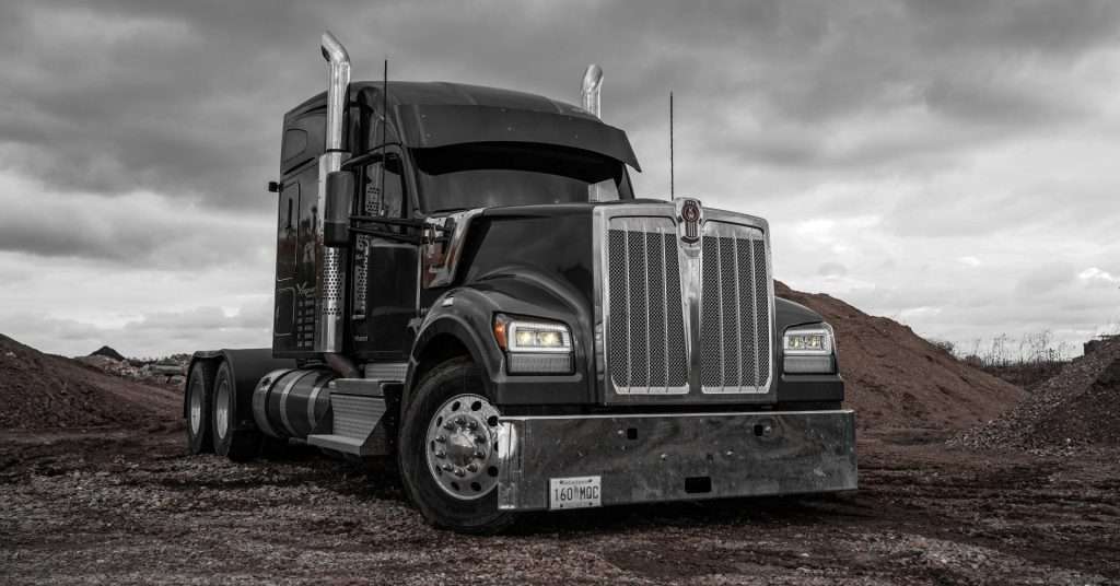 2023 grey Kenworth W990 with BTS Lighting Bi-Beam LED headlights amber light output