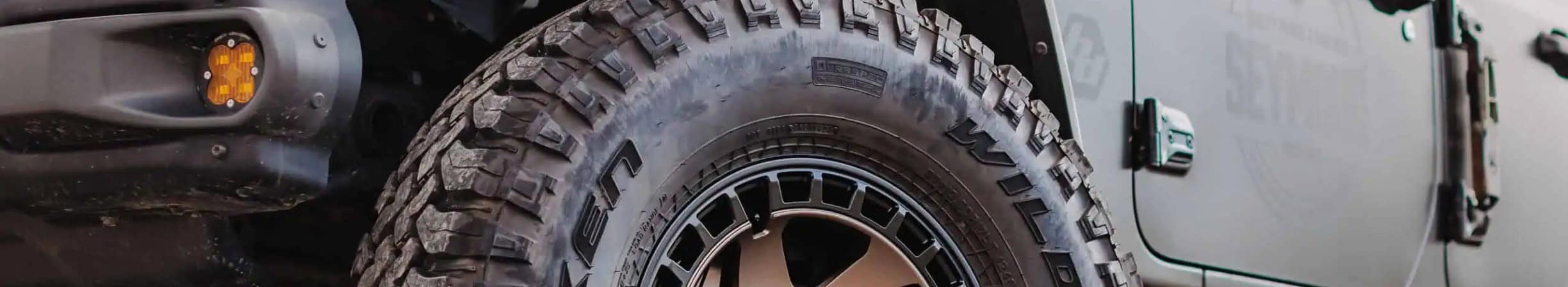 Mud-terrain tire on a lifted Jeep Gladiator — automotive tires from BTS Lighting & Accessories, Canada