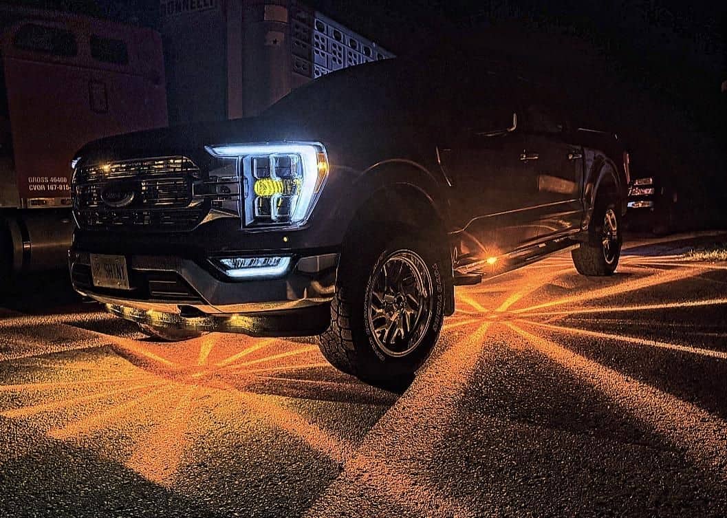 Black Ford pickup with amber Glass Is Class Gen 2 starbursts beneath the front, cab and bed