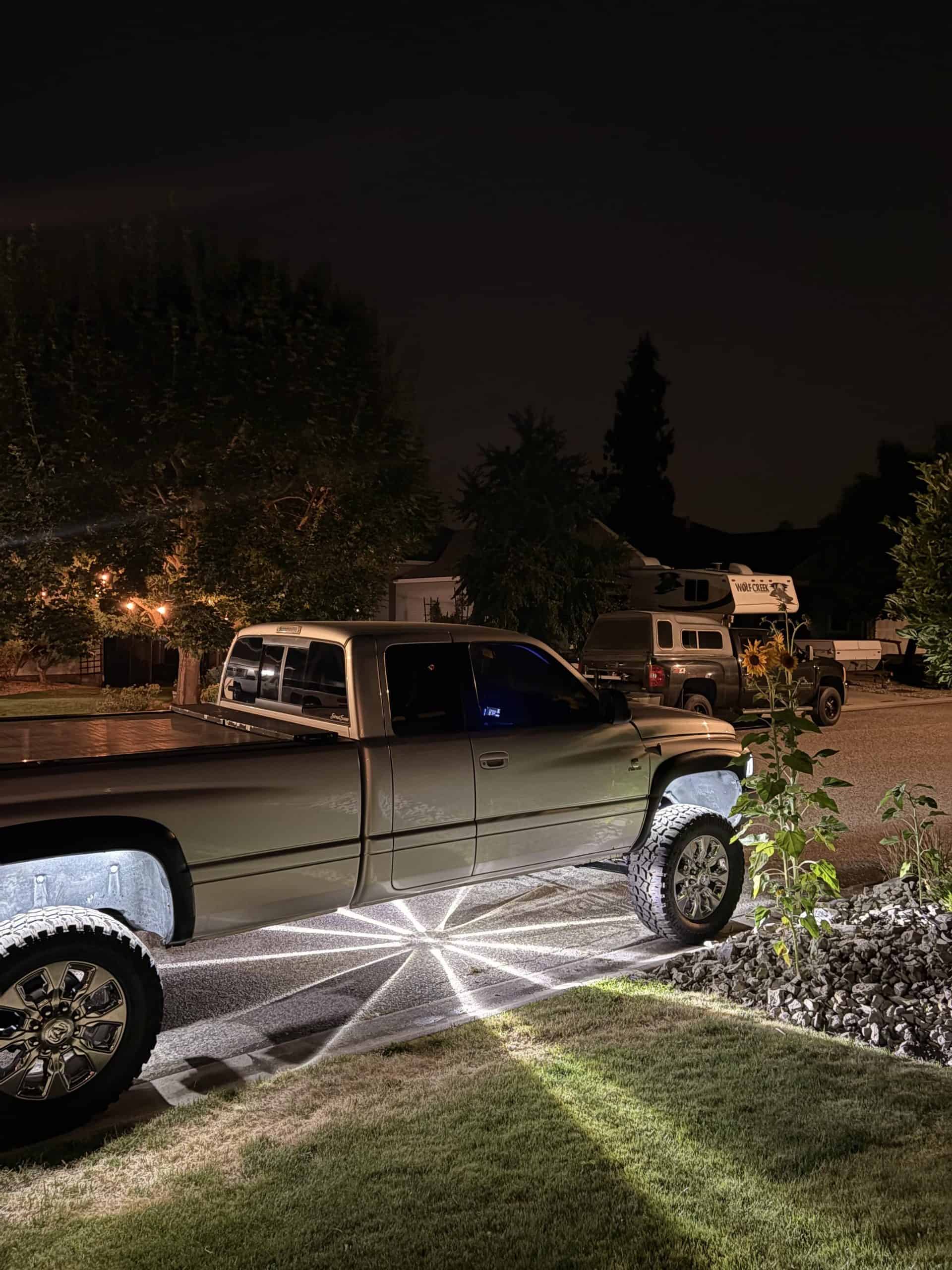 Silver custom pickup with white Glass Is Class Gen 2 starbursts beneath the cab and bed