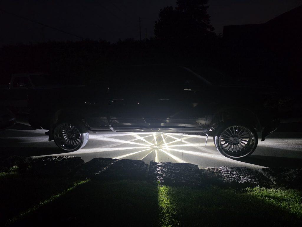 White Glass Is Class Gen 2 watermelon-light starbursts glowing beneath a black custom pickup