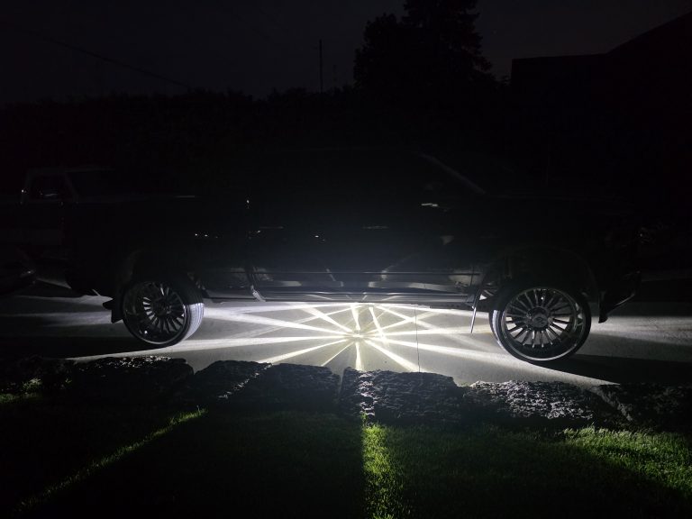 White Glass Is Class Gen 2 watermelon-light starbursts glowing beneath a black custom pickup