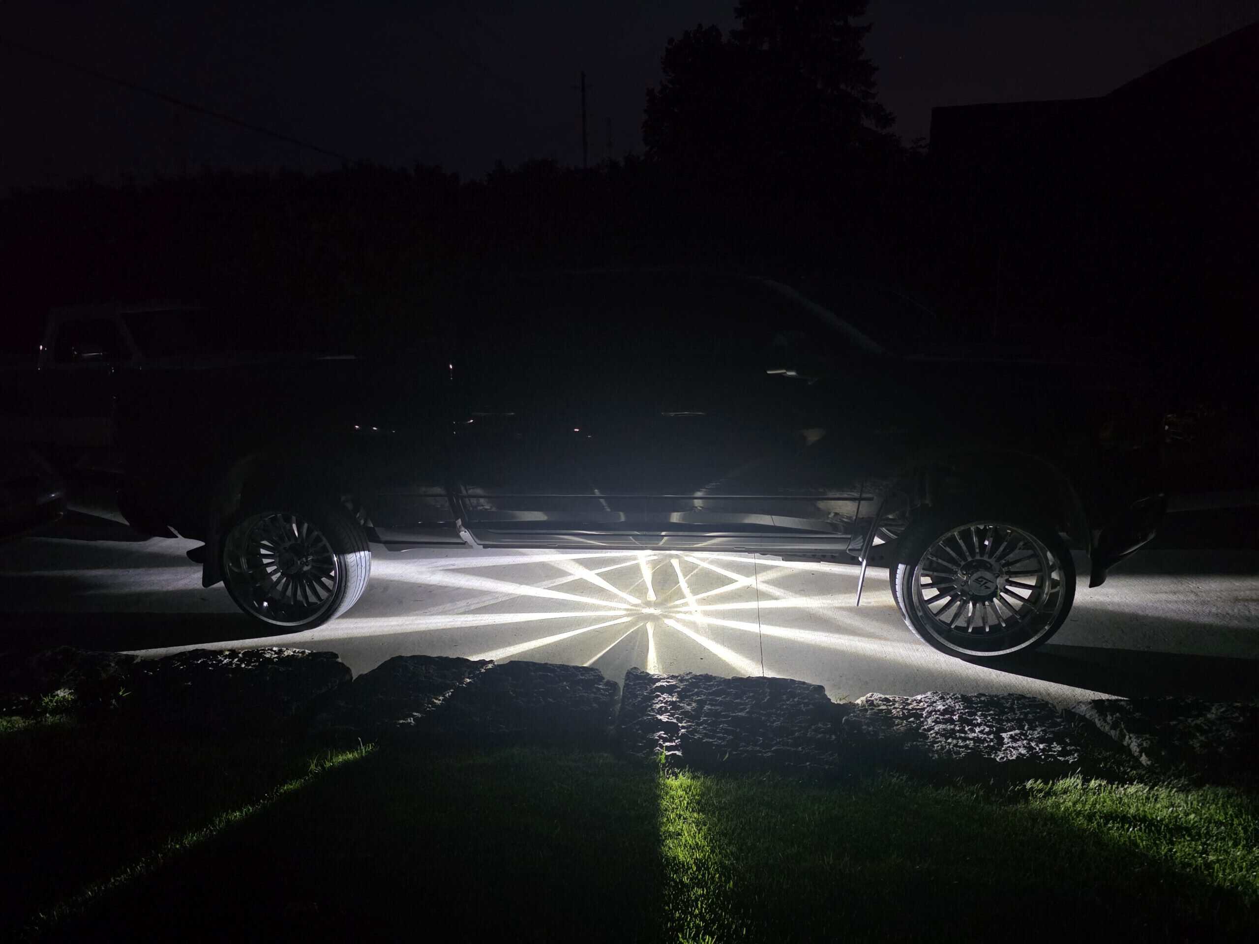 White Glass Is Class Gen 2 watermelon-light starbursts glowing beneath a black custom pickup