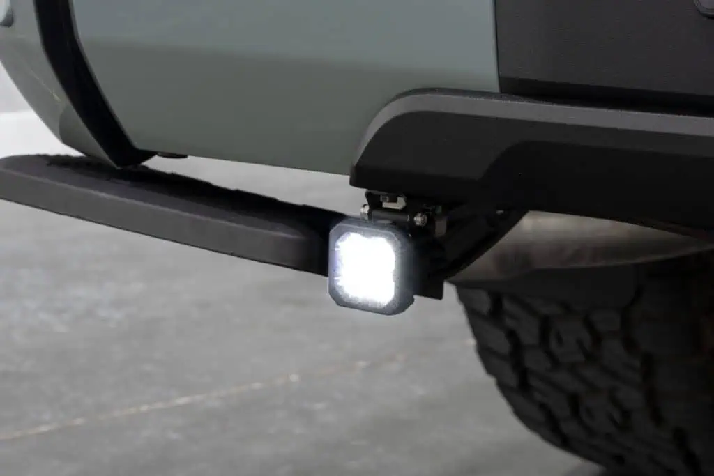 Diode Dynamics Stage Series Reverse Light Kit For 2022–2026 Toyota Tundra C1 35 C1 pod mounted below the Tundra rear bumper with the white reverse light on.
