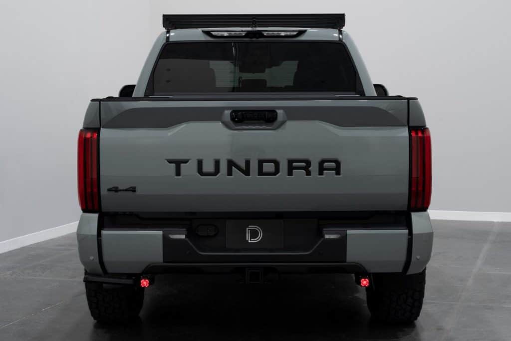 Diode Dynamics Stage Series Reverse Light Kit For 2022–2026 Toyota Tundra C1 41 Two C1 pods showing their red accent backlights below the Tundra bumper.
