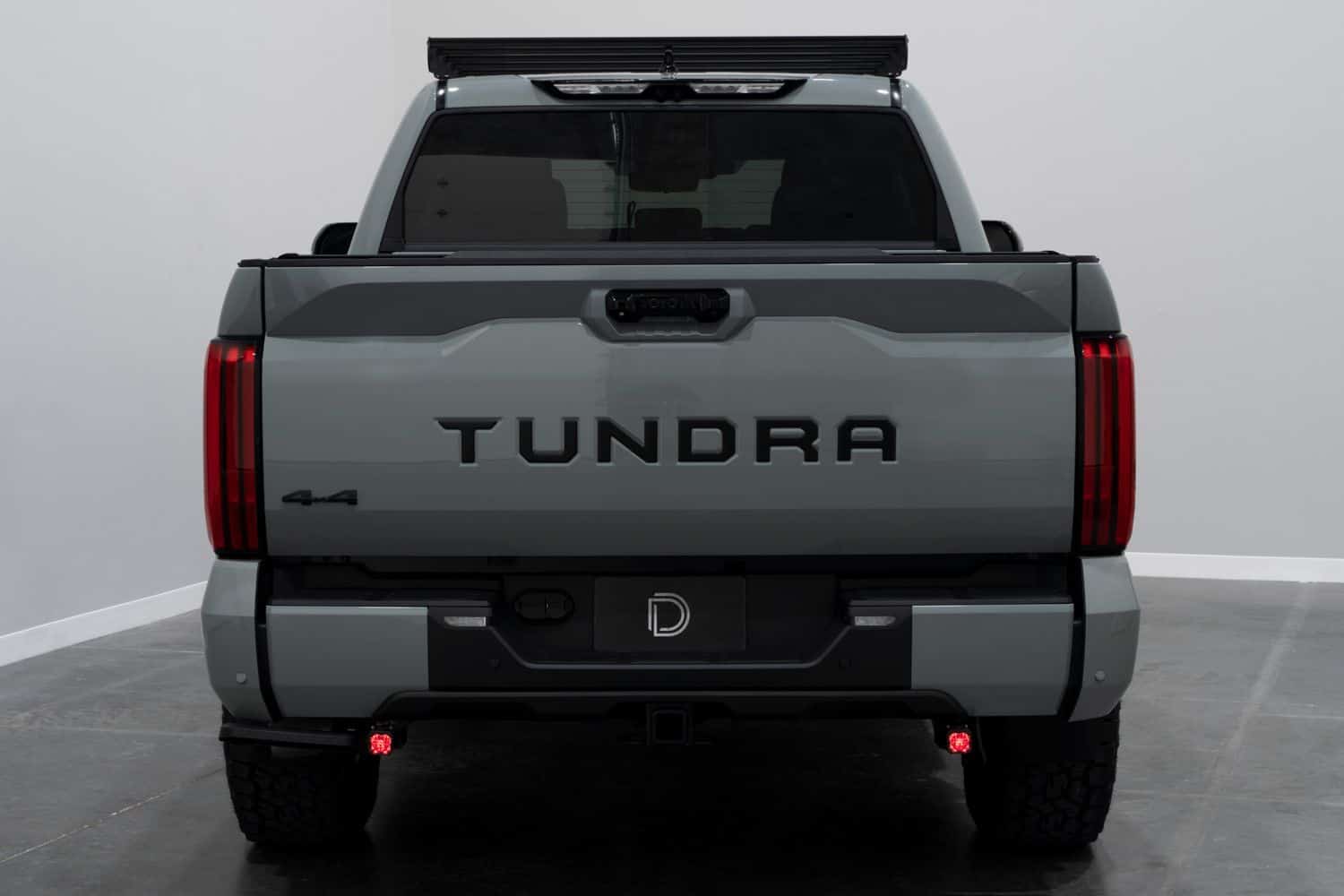 Diode Dynamics Stage Series Reverse Light Kit For 2022–2026 Toyota Tundra C1 6 Two C1 pods showing their red accent backlights below the Tundra bumper.
