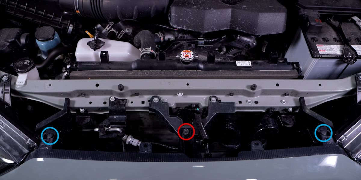 2014–2024 Toyota 4Runner Form Headlight Installation Guide 4 Remove the central bolt and two upper-grille clips.