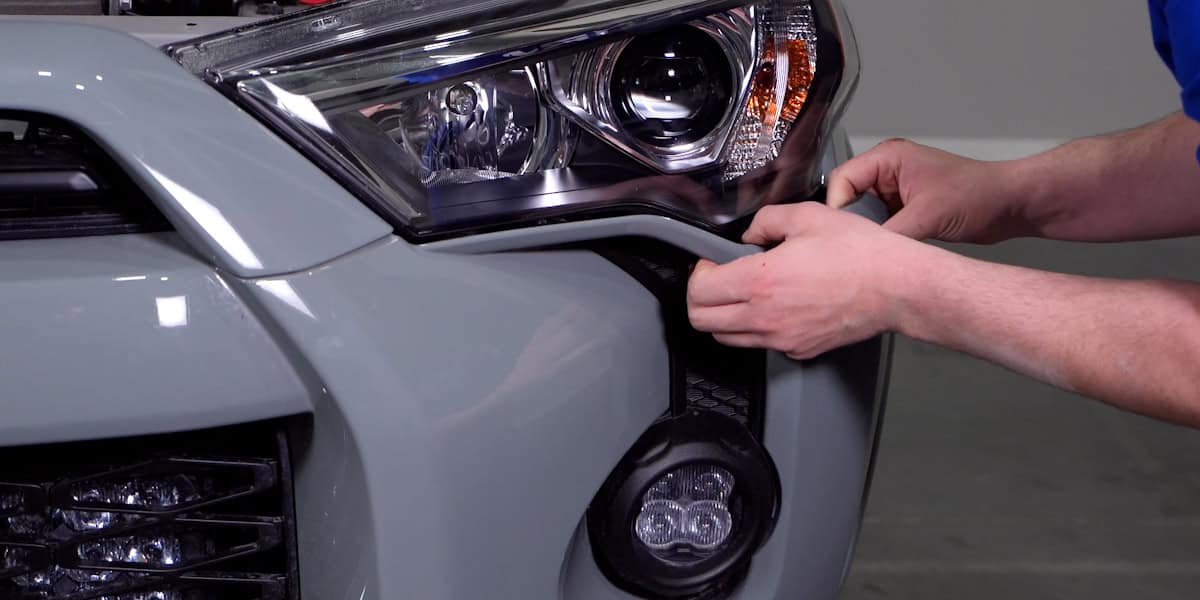 2014–2024 Toyota 4Runner Form Headlight Installation Guide 11 Work inward from the bumper corners to release the bumper.