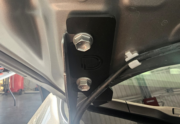 2019–2025 Toyota Rav4 C2 2.0 And Ss3 Ditch-Light Installation Guide 1 Fit the RAV4 bracket at the hood hinge and keep the washer-fluid line clear.