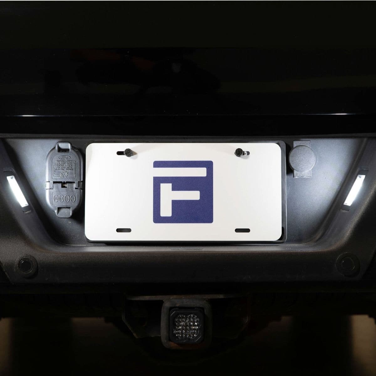Form Led License Plate Lights For 2015–2023 Ford F-150 (Pair) 15 An F-150 rear-bumper installation with the license-plate lamps illuminated.
