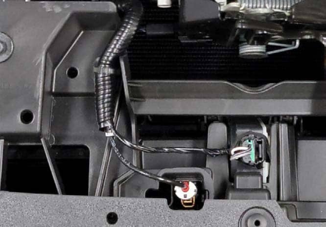 2021–2023 Ford F-150 Ss5 Crosslink Installation And Backlight Guide 4 Harness connectors and retaining clip near the hood latch.
