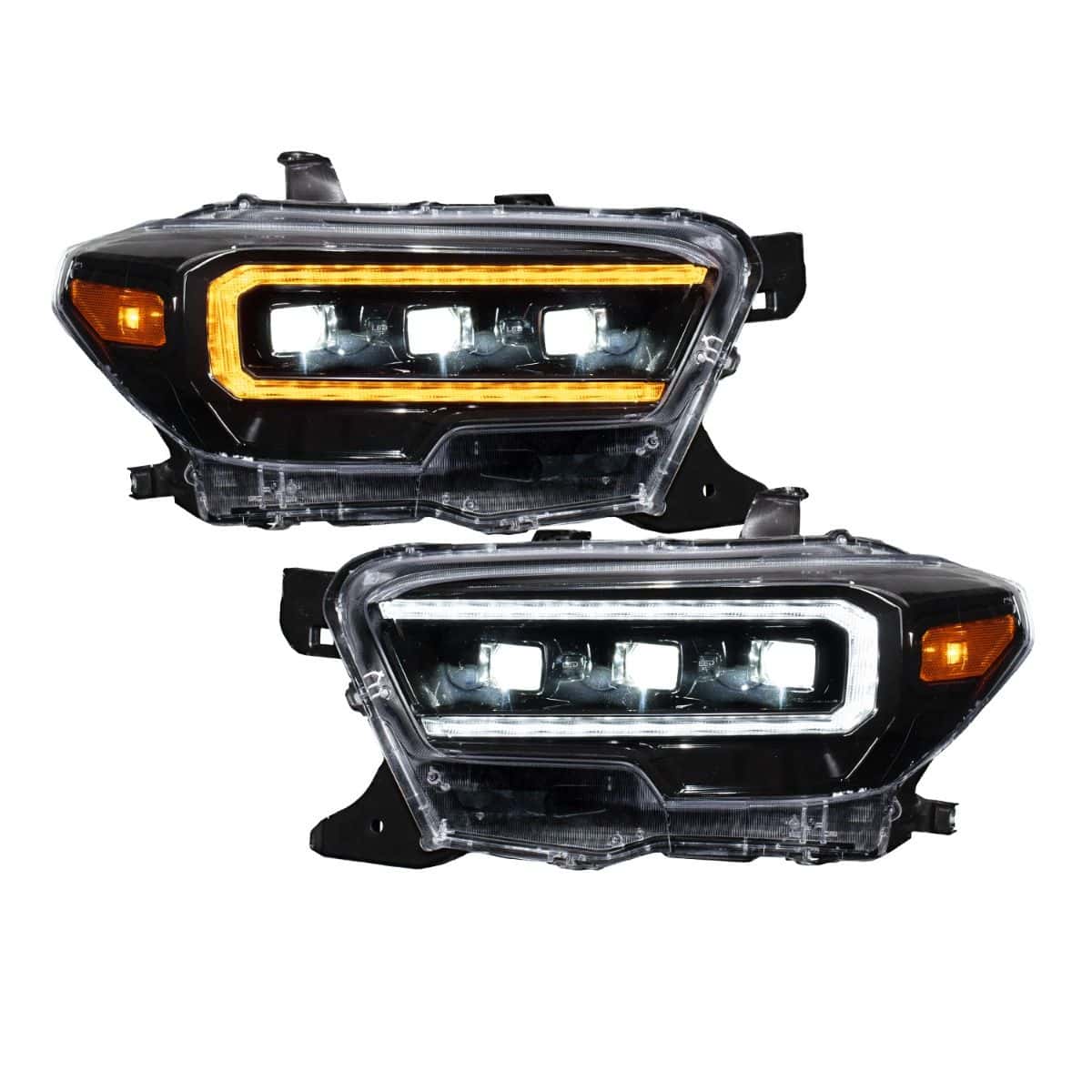 Current black-bezel Tacoma headlight pair, illuminated.