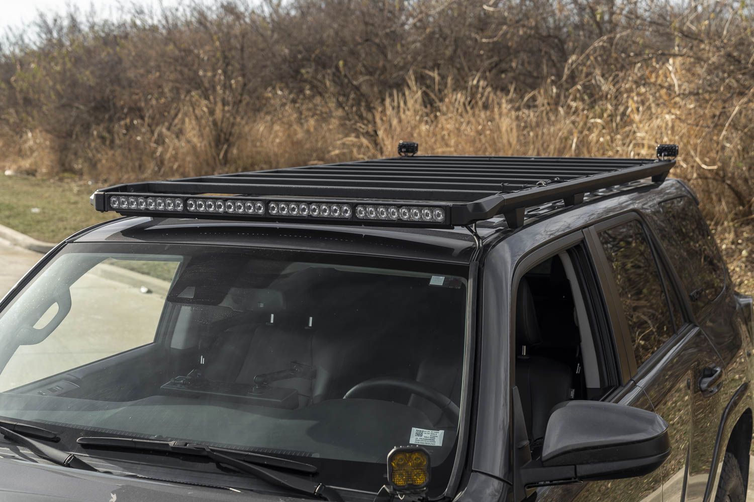 SS40 lightbar integrated into a Kuat DEK roof rack on a Toyota 4Runner; other pictured lights are separate.