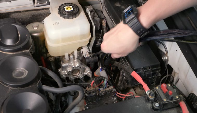 2010–2024 Toyota 4Runner Reverse-Light Installation Guide 8 Manufacturer engine-bay wiring example. This reference photograph does not show the entire rear-to-front harness route.