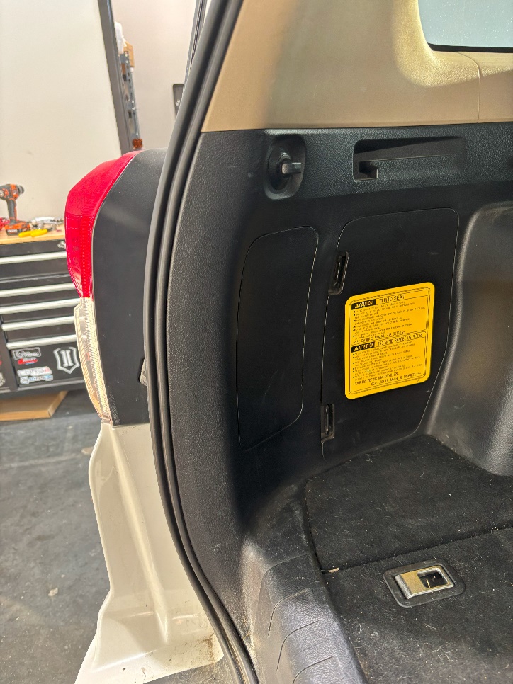 Form Tail-Light Installation: 2010–2024 Toyota 4Runner 2 Release the interior access panel from its opening.