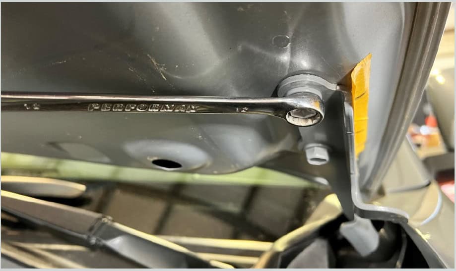 Tacoma Morimoto Ditch-Light Bracket Installation Guide 6 Support the hood while removing the two 12mm-head hinge bolts on the working side.