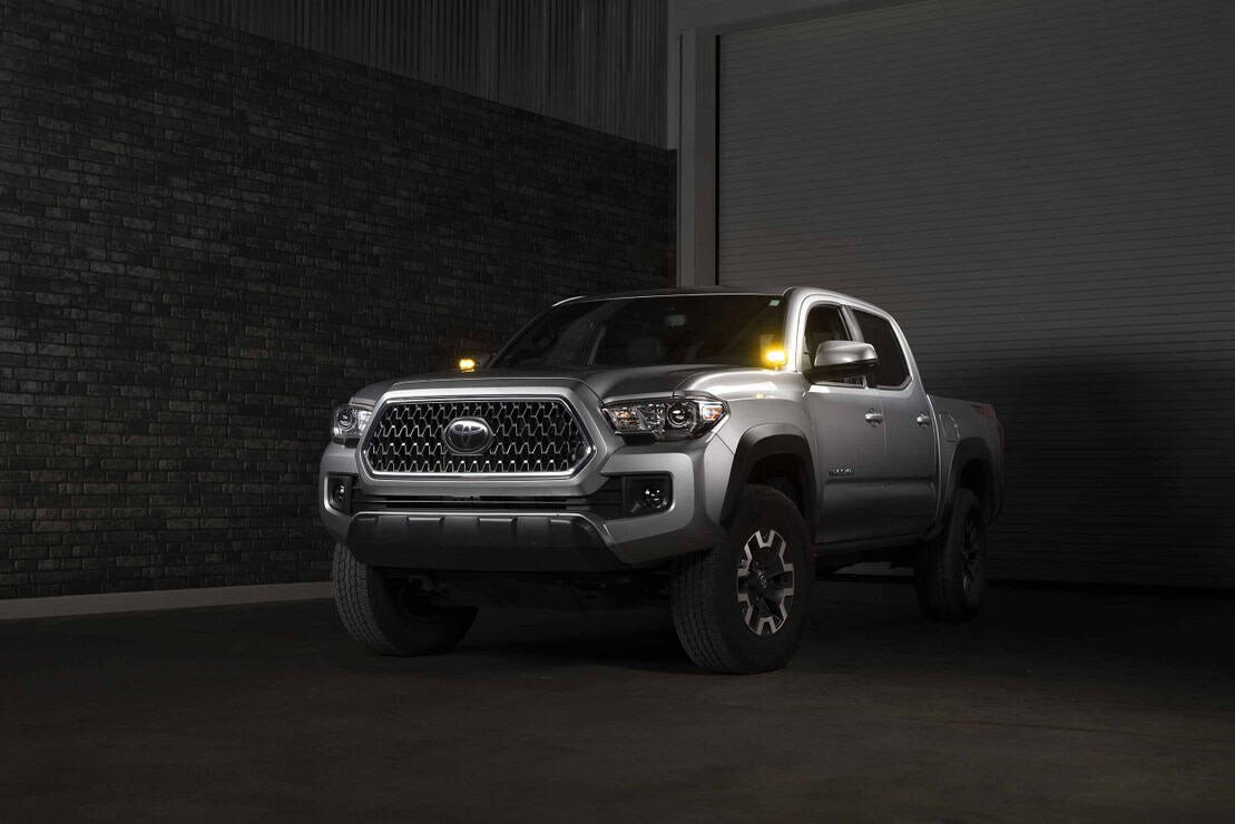Morimoto 2Banger Complete Ditch Light Kit For 2016–2023 Toyota Tacoma 9 Tacoma installation with yellow pods; other accessories not included.