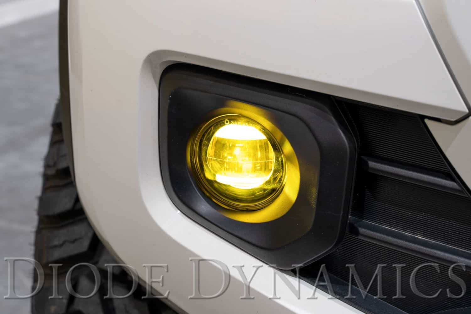 Elite Yellow fog light installed on a manufacturer example Tacoma.