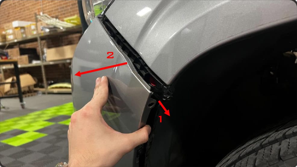 2016–2023 Tacoma Morimoto Evo Headlight Installation Guide 13 Release the bumper corner from its retaining tabs.
