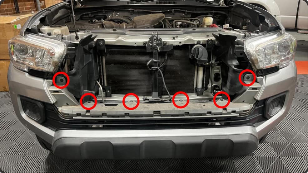 2016–2023 Tacoma Morimoto Evo Headlight Installation Guide 7 Remove the six clips across the top of the bumper.