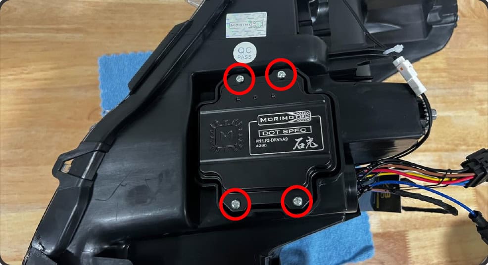 2016–2023 Tacoma Morimoto Evo Headlight Installation Guide 22 Optional Supercharged upgrade: remove the four driver screws.