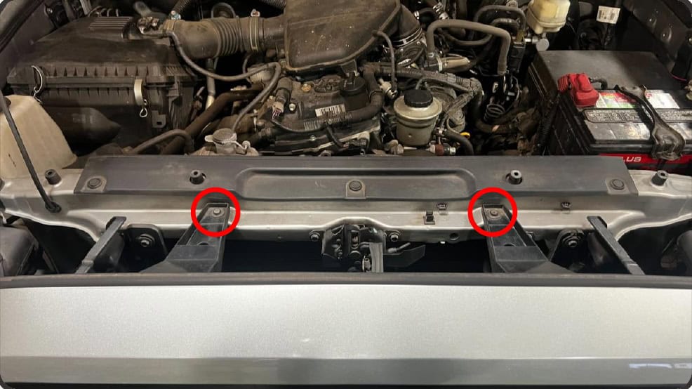 2016–2023 Tacoma Morimoto Evo Headlight Installation Guide 2 Remove the two upper grille bolts.