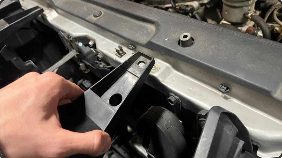 2016–2023 Tacoma Morimoto Evo Headlight Installation Guide 5 Lift the upper brackets and pull the grille forward.
