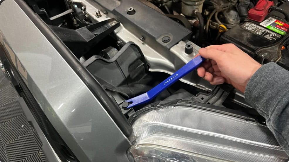 2016–2023 Tacoma Morimoto Evo Headlight Installation Guide 3 Release the two outer upper grille clips.
