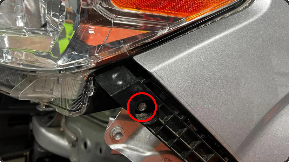 2016–2023 Tacoma Morimoto Evo Headlight Installation Guide 14 Remove the bolt at the side of the headlight bracket.