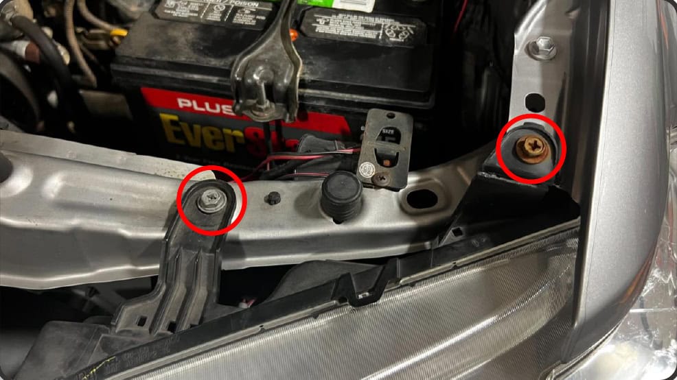 2016–2023 Tacoma Morimoto Evo Headlight Installation Guide 15 Remove the two upper headlight bolts and lift the tabs.