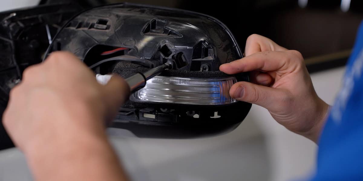 Install Form Mirror Turn-Signal Lights On Your Tacoma 4 Remove the two lamp-retaining screws.