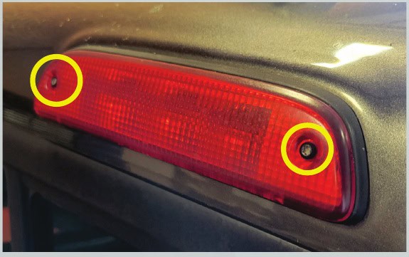 Toyota Tacoma Morimoto X3B Third Brake-Light Installation Guide 3 Remove the two outside lamp screws with a driver that matches their heads.