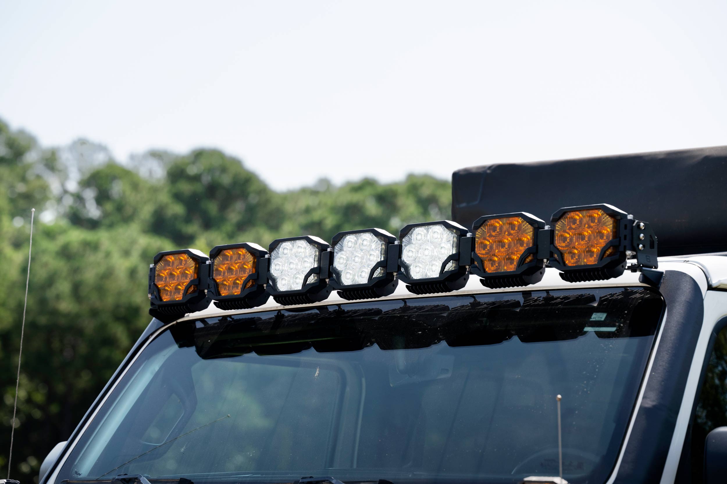 Morimoto Bigbanger 7-Pod Roof Light-Bar Kit For 2018–2026 Jeep Wrangler Jl 9 Representative assembled kit. Select the listed output level, colour and optic; other vehicle lighting in installation photos is not included.